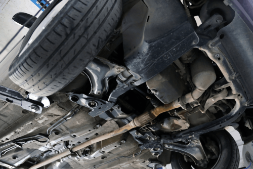 Driveline repair in Belton, MO at Belton Transmission & Complete Auto Repair. Image of a vehicle undercarriage showing driveline and suspension components during inspection and service.