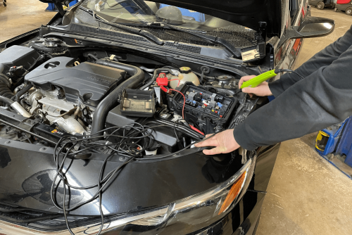 Auto electrical repair in Belton, MO by Belton Transmission & Complete Auto Repair. Image of a technician testing circuits under the hood with diagnostic tools connected. Highlighting the shop’s commitment to accurate electrical troubleshooting and dependable vehicle performance.