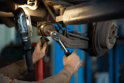 Steering repair in Belton, MO at Belton Transmission & Complete Auto Repair. Image of technician working on drivetrain components, highlighting precise service, durability, and dependable performance for your vehicle.