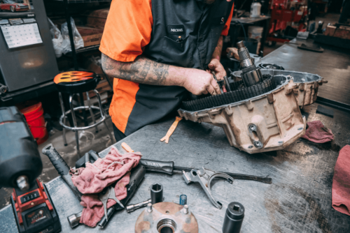 Transfer case and differential repair in Belton, MO by Belton Transmission & Complete Auto Repair. Image of a technician working on transmission gears and components, highlighting precision workmanship, improved shifting performance, and dependable drivetrain reliability.